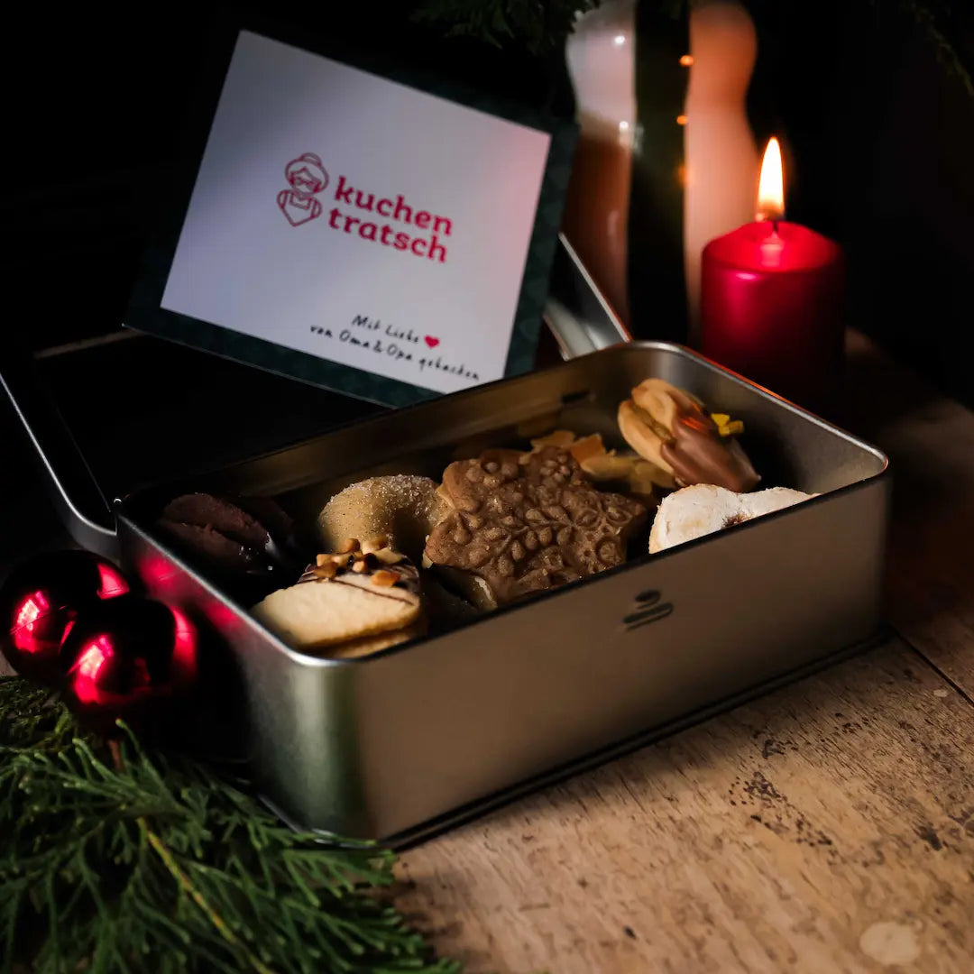 Bunte Auswahl veganer Weihnachtsplätzchen in Versandbox mit liebevoll gebackenen Sorten von Omas